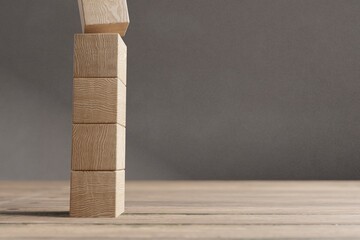 Arranged wood cube stacking as shape, mock up for create symbol, business growth and management concept.