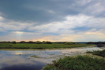 Small meandering rural river in the evening.