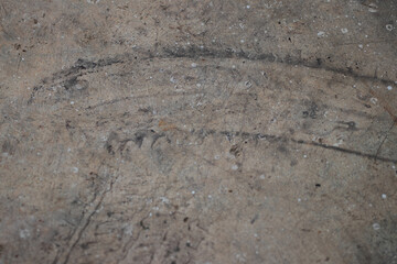 Textured of tire marks or footprint on the dirty concrete or cement floor in car park as grunge background