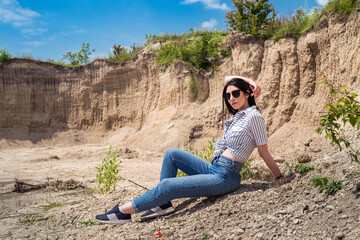 slim young pretty woman relax on nature against the background of the desert