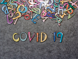 COVID-19 Hand-drawn keyword colorful puzzle with grey furry background projection view