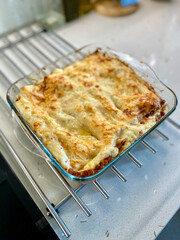 Whole Lasagna with Bechamel Sauce in Glass Tray Ready to Serve and Eat.