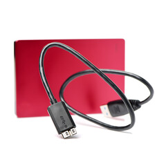 Red external hard drive with usb cable on the white background