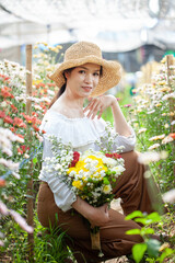 Fototapeta premium Beautiful asian woman in the flower garden
