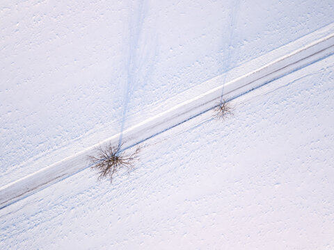 winter road, landscape covered by fresh snow, top down aerial view, landscape. Simplicity concept composition.