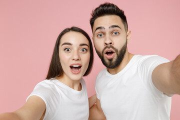 Close up young cheerful couple two friends man brunette woman in white basic blank print design...