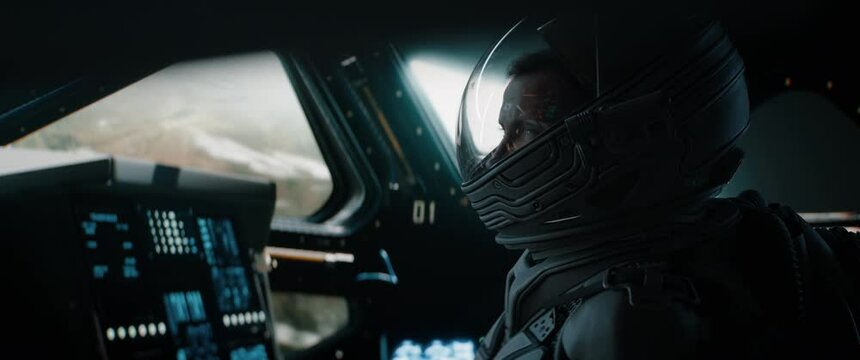 Portrait of Caucasian male astronaut inside spaceship cockpit. Sci-fi space exploration concept. Shot with 2x Anamorphic lens