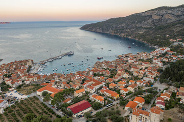 Aerial overhead done shot of Komiza town port on Vis Island in Croatia before sunrise