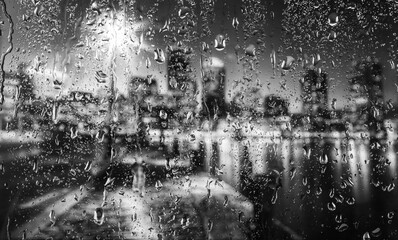 City view through the glass in the rain. Not real city.