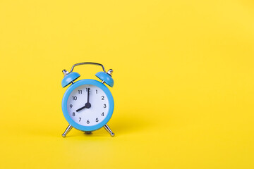 The alarm clock shows 8 am. Morning time. Clock face. Yellow background, deadline concept. Copy...