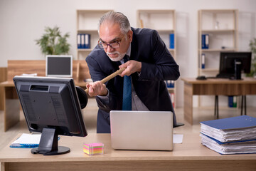Old businessman employee holding plunger at workplace