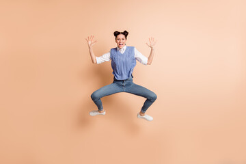 Fototapeta na wymiar Full size photo of brunette impressed lady jump wear white shirt blue vest jeans sneakers isolated on beige color background