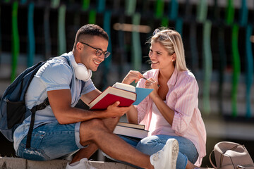 Couple with books outdoors