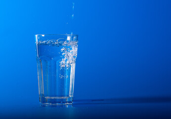 Fresh water bottles on blue background