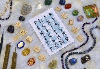 Still life with runes, chakras symbols on stones and ritual objects.
