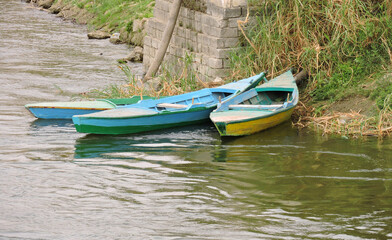 Three colorful rowboats on the bank of the Nile