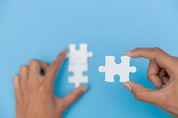 Jigsaw connection, Jigsaw puzzle in the hand of a businessman,  Business team assembling Jigsaw puzzle.