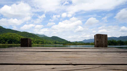 Panoramic view of Wooden bridge lake with Green mountain, bright blue sky and lake at the background with Empty wooden floor. can be used for display product Mock Up. Panoramic Nature Scene.