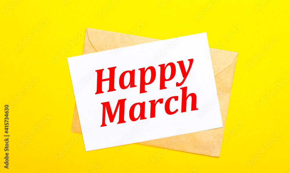 Poster on a yellow background, an envelope and a card with the text happy march. view from above