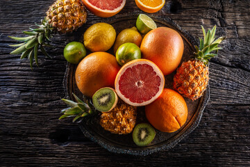 Top view of exotic fruit and citruses on a vintage wood
