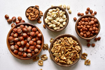 Dry nuts in a wooden bowls. Top view with copy space.