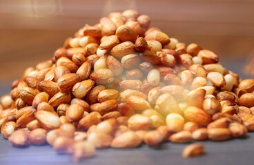 A heap in the form of a slide of pine nuts from Siberia, peeled from the shell, close-up.
