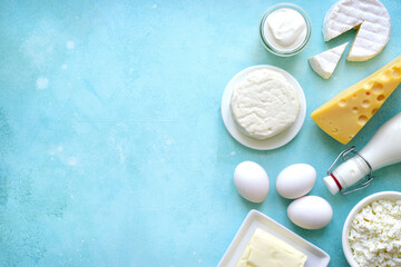 Fresh organic dairy products : butter, eggs, milk, cheese, cream. Top view with copy space.