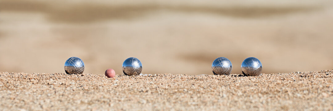 Metallic petanque four balls and a small wood jack