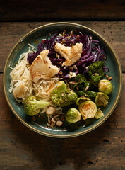 Appetizing noodles with grilled cabbages on table