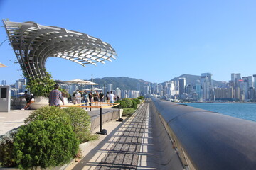 View of Victoria Harbour from the Avenue of Stars on a Sunny Day in Hong Kong