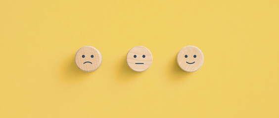 Wooden blocks with the happy face smile face symbol on yellow background, evaluation, Increase rating, Customer experience, satisfaction and best excellent services rating concept