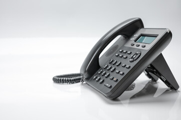 Telephone set with display and buttons. Modern phone for ip-telephony. Isolated, white background.