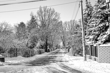 narrow city side road in winter snowy sunny day