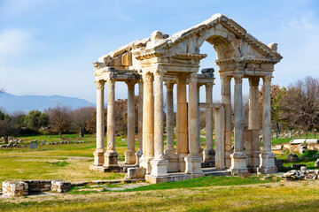 Fototapeta na wymiar Monumental gateway or tetrapylon preserved to this day in small ancient Greek city of Aphrodisias in historic Caria cultural region, Turkey..