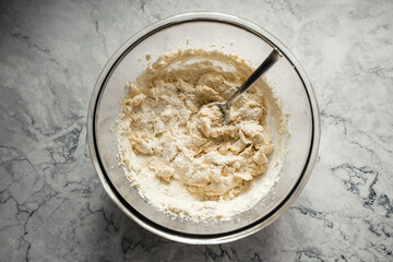 Baking cookies. Dough in a big glass bowl. Top view horizontal photo.