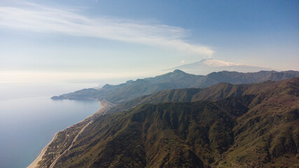 Aerial view from the north of the Etna volcano and the Ionian coast