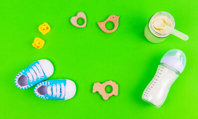 various accessories for babies. green background. selective focus.