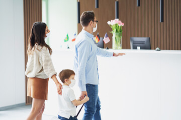 Picture of family checking in hotel