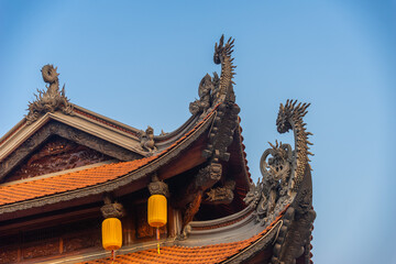 Beautiful traditional decorations and details on the roof of the temple at Vinh Nghiem monastery in Ho Chi Minh city, Vietnam