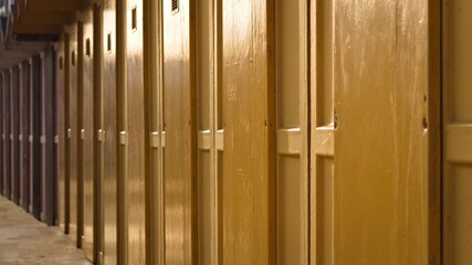 A series of yellow beach huts in a bathing establishment on the Mediterranean coast (Pesaro, Italy,...