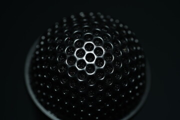 Close-up shot of honey comb mic isolated on black background. 