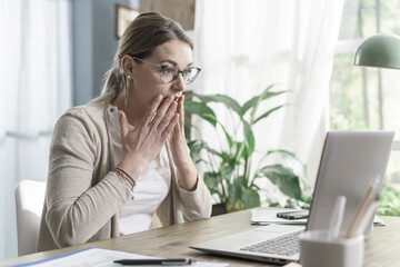 Stressed woman receiving bad news online
