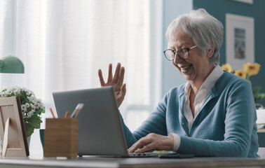 Senior woman having a video call at home