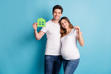 Photo portrait of two people happy couple holding key from new home pregnant wife waiting baby isolated vivid blue color background