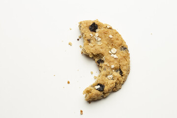 Top view of a half eaten cookie with small chocolate chips isolated on a white background
