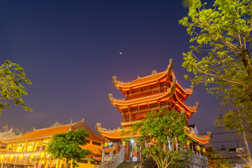 Beautiful traditional decorations and details on the roof of the temple at Vinh Nghiem monastery with many visitor in Ho Chi Minh city, Vietnam