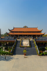 Fototapeta premium Beautiful traditional decorations and details on the roof of the temple at Vinh Nghiem monastery with many visitor in Ho Chi Minh city, Vietnam