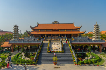 Beautiful traditional decorations and details on the roof of the temple at Vinh Nghiem monastery with many visitor in Ho Chi Minh city, Vietnam