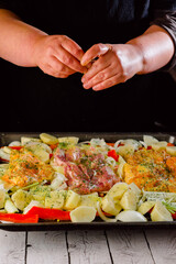 cook marinating the chicken thigh in the oven. Top view. on a baking sheet.