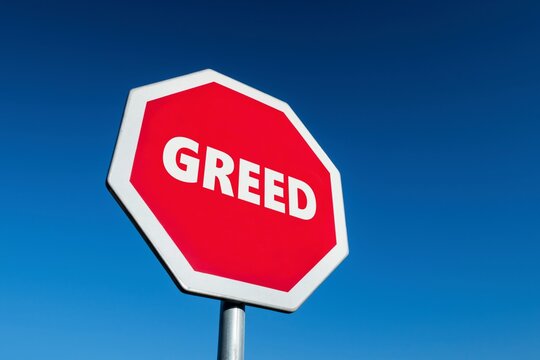 Stop GREED traffic sign to limit the cupidity and desire for money and luxury objects